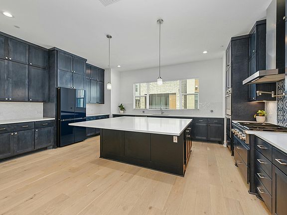 Gourmet kitchen, expansive island, double oven, full pantry, pot filler, built in microwave, abundant storage