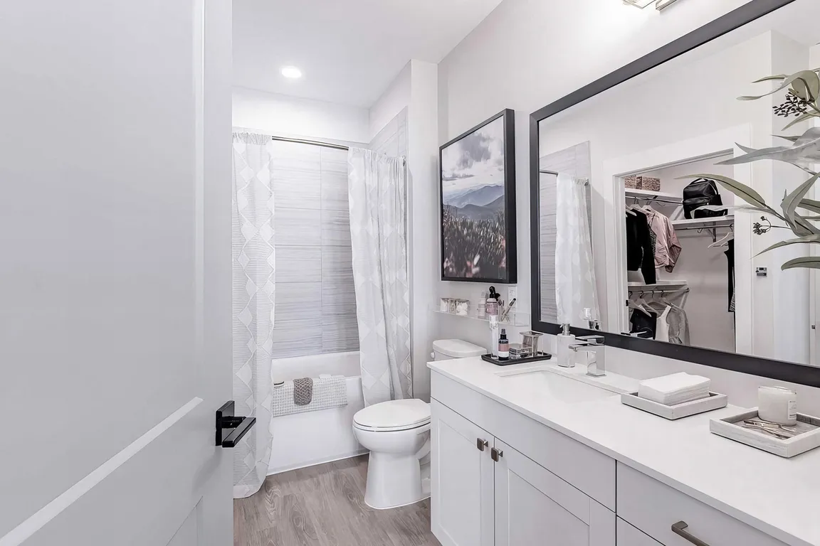 Full bathroom with a bathtub with tile backdrop