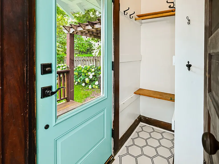 Backyard entrance and coat closet.