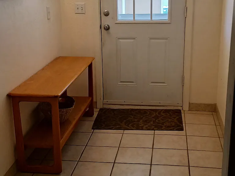 This is the entry way from the covered carport with a console table.