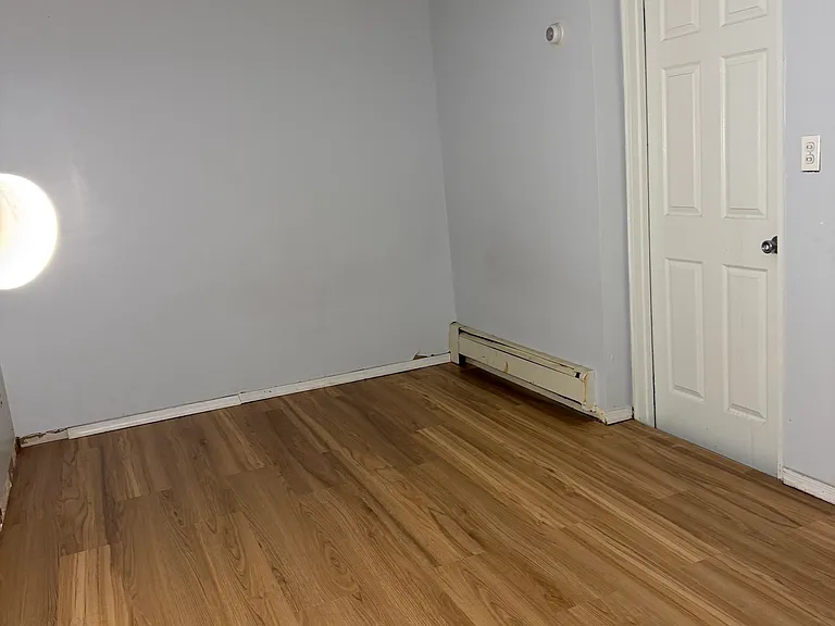 Newly renovated Vinyl Plank Flooring in bedroom that will fit a queen size bed perfectly.