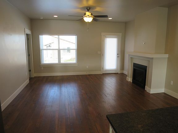 Living room with gas fireplace and door to back deck
