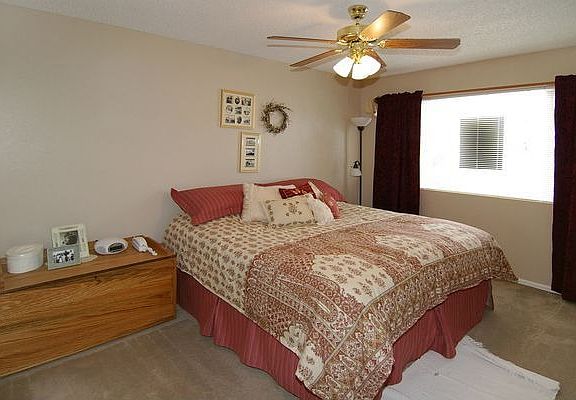 LARGE MASTER BEDROOM WITH PICTURE WINDOW AND CEILING FAN
