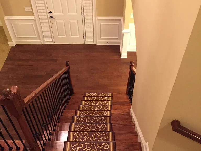 Hardwood floors on stairs - you go up the stairs from entry at front door, take right to go upstairs, take left to go downstairs to kitchen