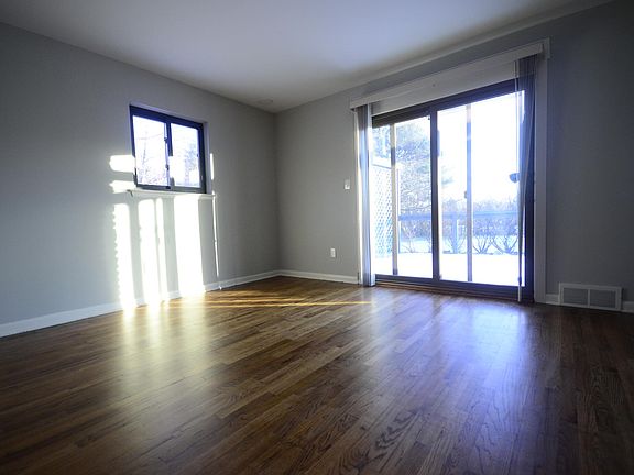 Master bedroom, large glass sliding door (facing south), plus a east facing window, fills the room with natural light. Walks out to deck.