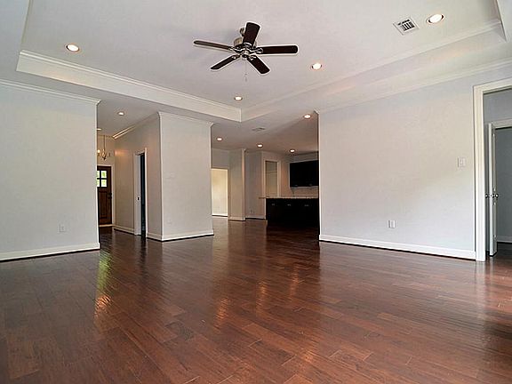 Large Living Area Features Hardwood Floors, Crown Molding, 10 Ft. Ceilings, Recessed Lighting and De