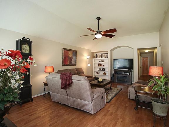 Step inside into this lovely large family room. Laminate floors make this room easy to clean. Freshly painted walls and baseboards make it like new! Large ceiling fan, 2" blinds, built-ins and lots of space!