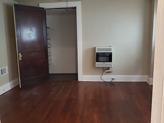 large walk-in closet with built in dresser and hanging space. Gas heater to supplement central heating.