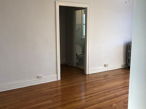 LR with bathroom in the background. Closet across from bathroom