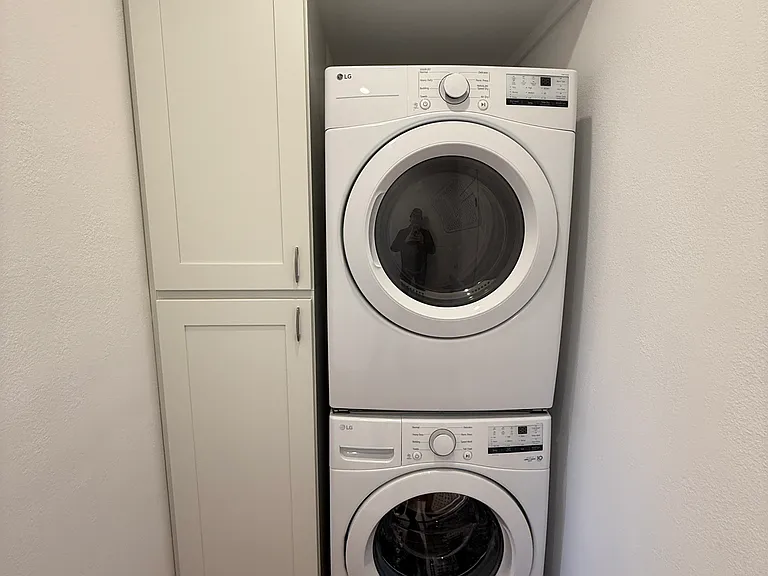 Separate in-unit full sized LG washer and dryer plus loads of linen and towel storage