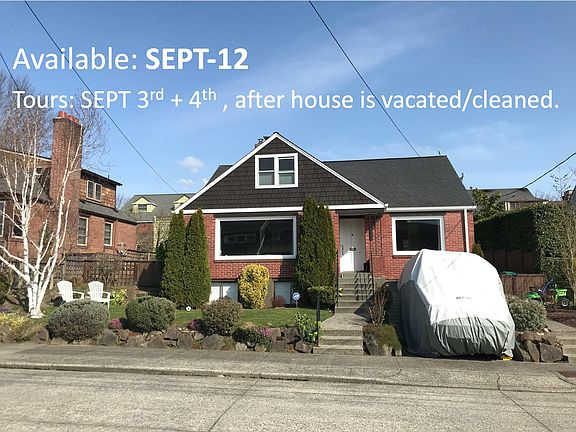 Front of house. Looking out WEST with views of the sunset and Olympic mountain tops. Backyard is fully fenced/gated. Shown here our van in the driveway - look at next image to see clear driveway.