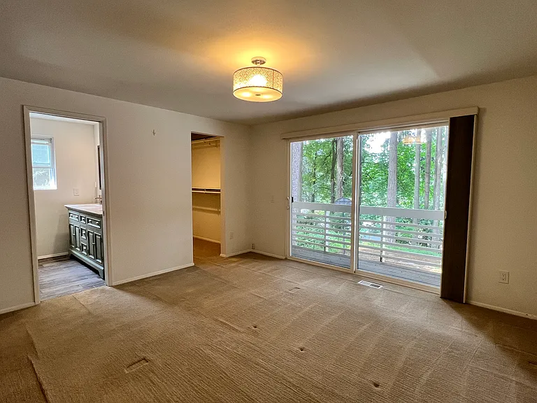 Private primary suite featuring a walk-in closet.