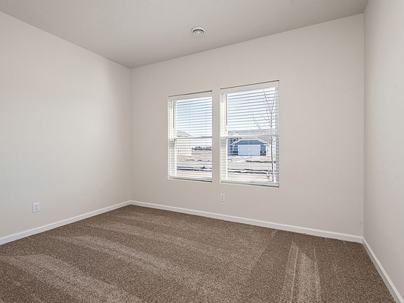 The master bedroom has a large window in the room.