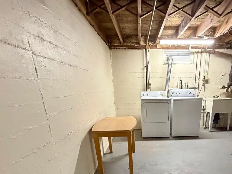 Washer, dryer and sink in the clean and dry basement.
