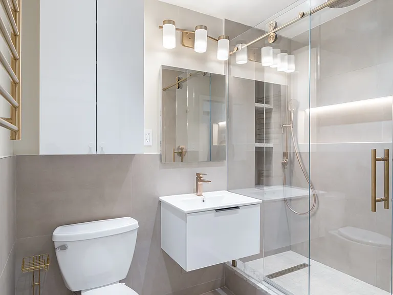 Towel warmer with rain-head shower and custom medicine cabinet and custom storage