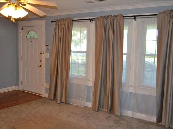 Living room has several double pane windows for natural lighting.