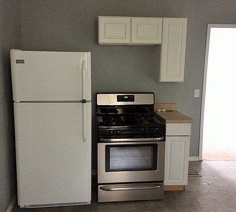 Kitchen with new fridge and stove