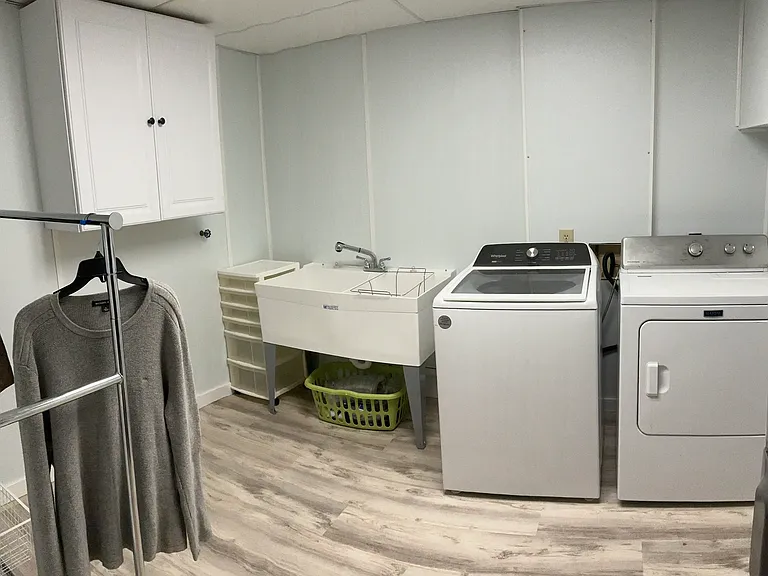 Washer and dryer and sink (sink not shown) included and this large storage area in laundry room has shelving on the left side.