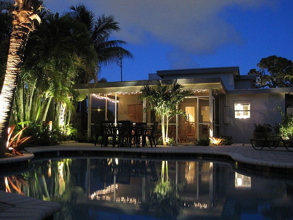 Pool, garden, screened porch by night