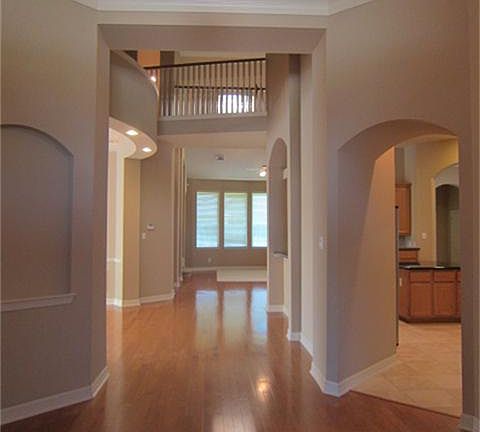 Entrance view, kitchen to right, formal dining to the left, family room at the end
