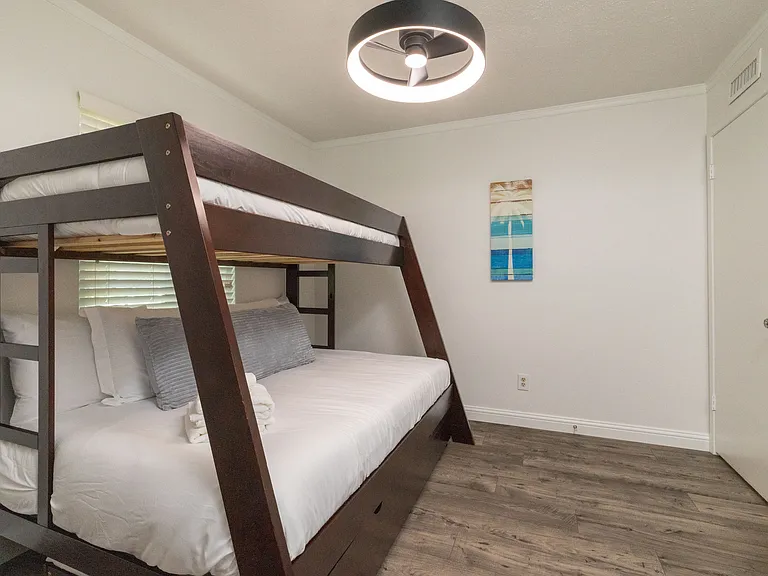 Bedroom 2 features a bunk bed with a double bed and single bed on top as well as flat-screen Roku TV, children books and kids games, perfect for the kiddos! There is also a spacious closet with a luggage rack and hangers for plenty of storage.