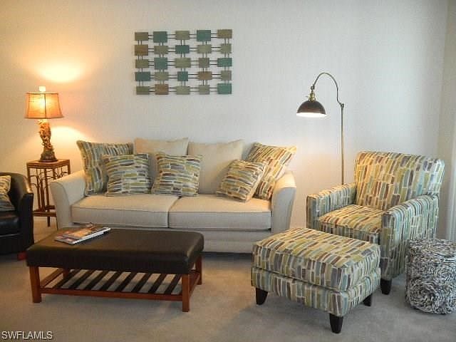 Open Livingroom with sliders to a screened in patio.
