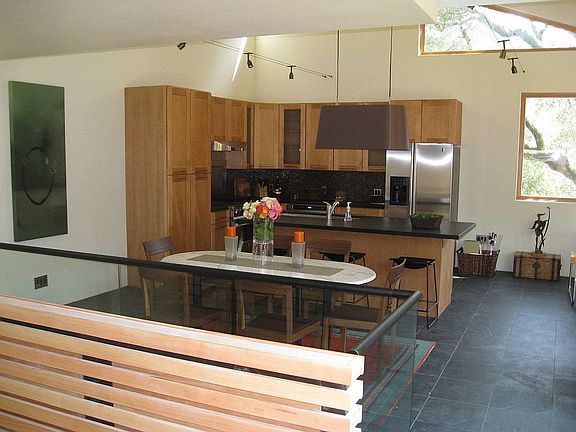 Great room overview, showing top of stairs, glass railing, kitchen area