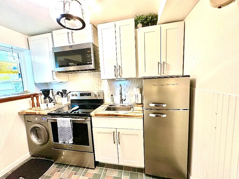 Small but mighty kitchen! With a non opening window allowing you to see whoever approaches the door.