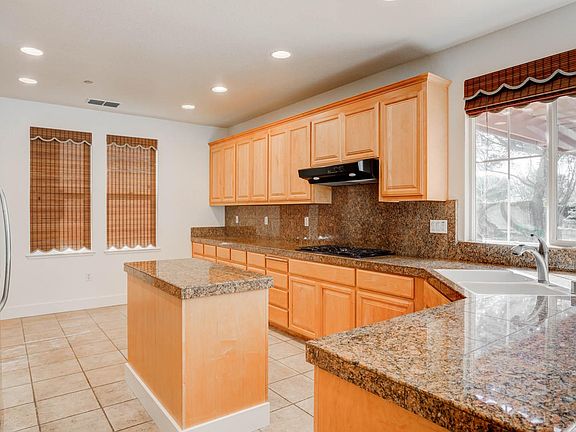 Kitchen with window looking into large backyard