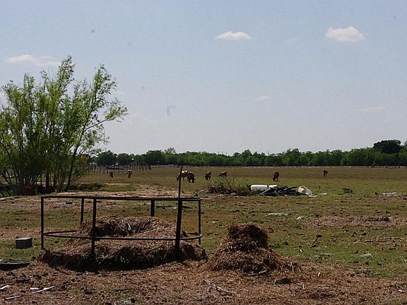 Property has a small house that can be leased out until commercial developement is feasible.