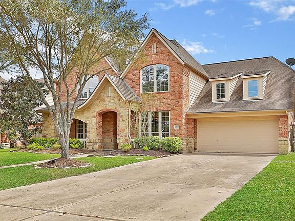 Traditional David Weekly home with tandem 3 car garage and wide driveway for additional parking. Beautiful landscape lighting is installed in the front yard.