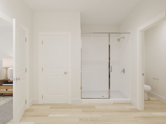 The primary bathroom offers dual vanity sinks and a walk-in shower.