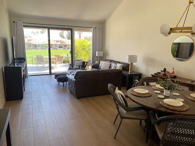 Open living and dining room with views to the rear patio and golf course.