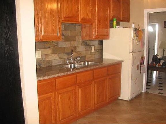 New granite countertops, cabinets, tile flooring, oven/stove
