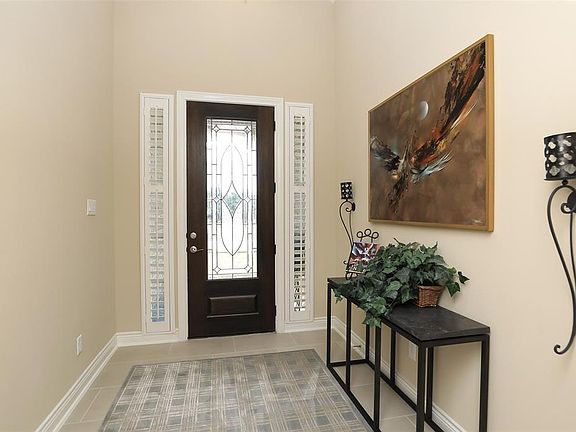 Plantation shutters enhance the sidelights for that custom touch.