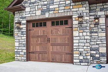 beautiful garage doors and stone work