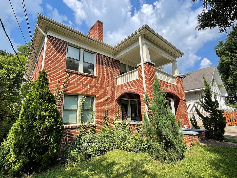 A stately building facing south and illuminated by landscape lighting at night.