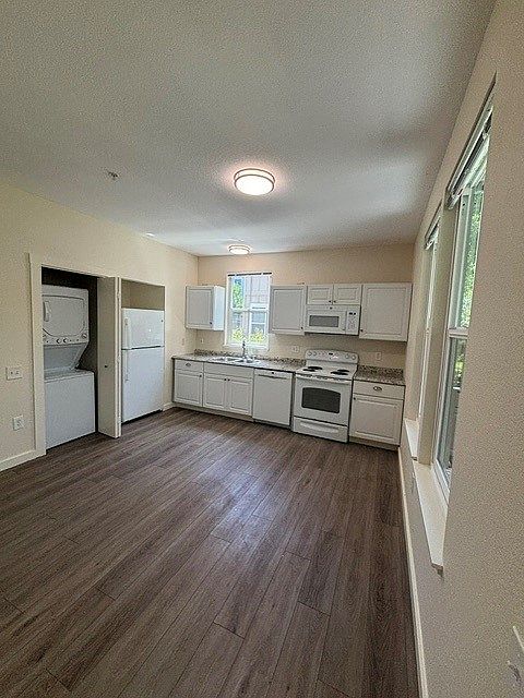 Kitchen includes eletric range, microwave, dishwasher, refrigerator/freezer, and stackable washer/dryer.