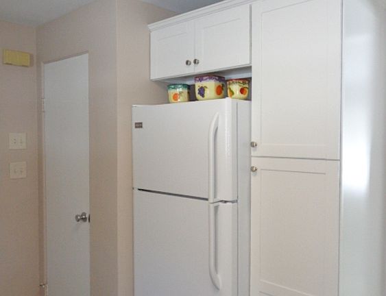 More cabinets and a closet in the kitchen near the entrance to the garage.
