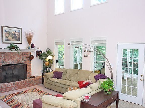 sunken living room, with tile floor and masonry fire place