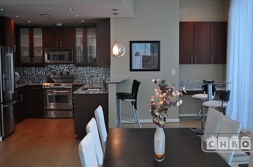 View of the kitchen, dining room, and a spare office space