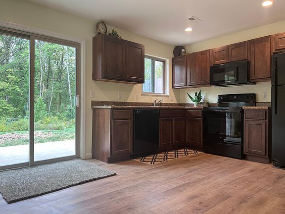 spacious kitchen with private walk out patio to wooded area