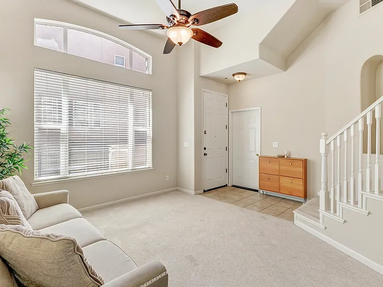 Living Room with front door to patio and door to garage