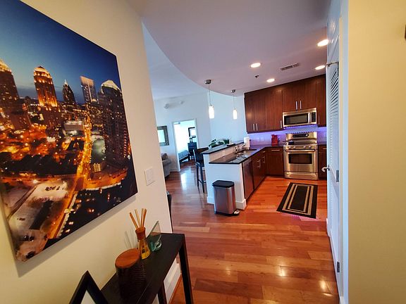 Foyer and kitchen as seen walking in the front door. Condo come furnished and decorated as pictured.