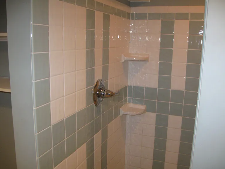 Lower-level walk-in style shower, all dressed up in a favorite spa color of aqua blue and white.