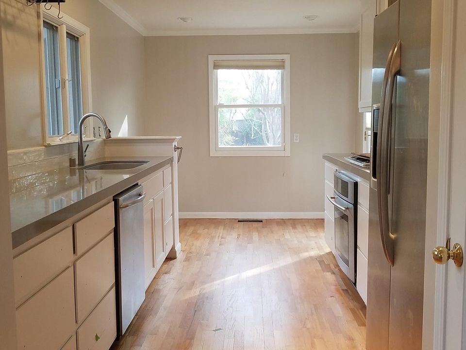 Kitchen with quartz counters, stanless steel appliances, gas stove, pull out faucet, extra deep sink, pantry, door takes you onto backyard deck.