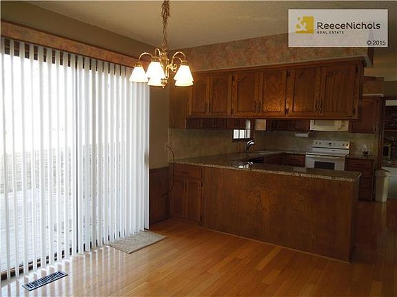 Large eat in area with entrance to back patio.