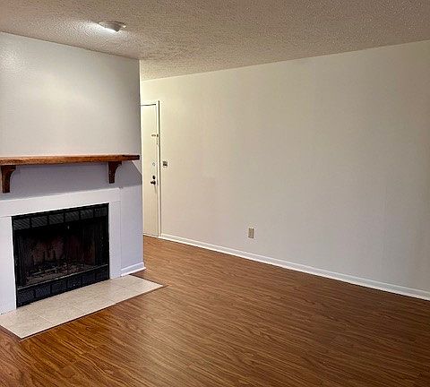 Another living room view from the dining area. Wood burning fireplace