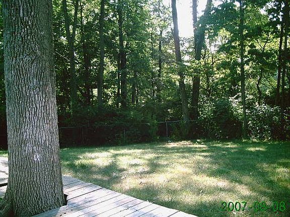 Fenced yard with mature trees 