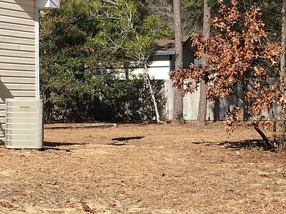 Right facing side yard view of back yard corner